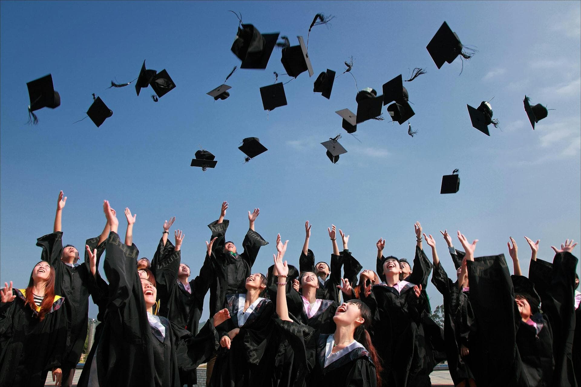 Graduates throwing caps in the air
