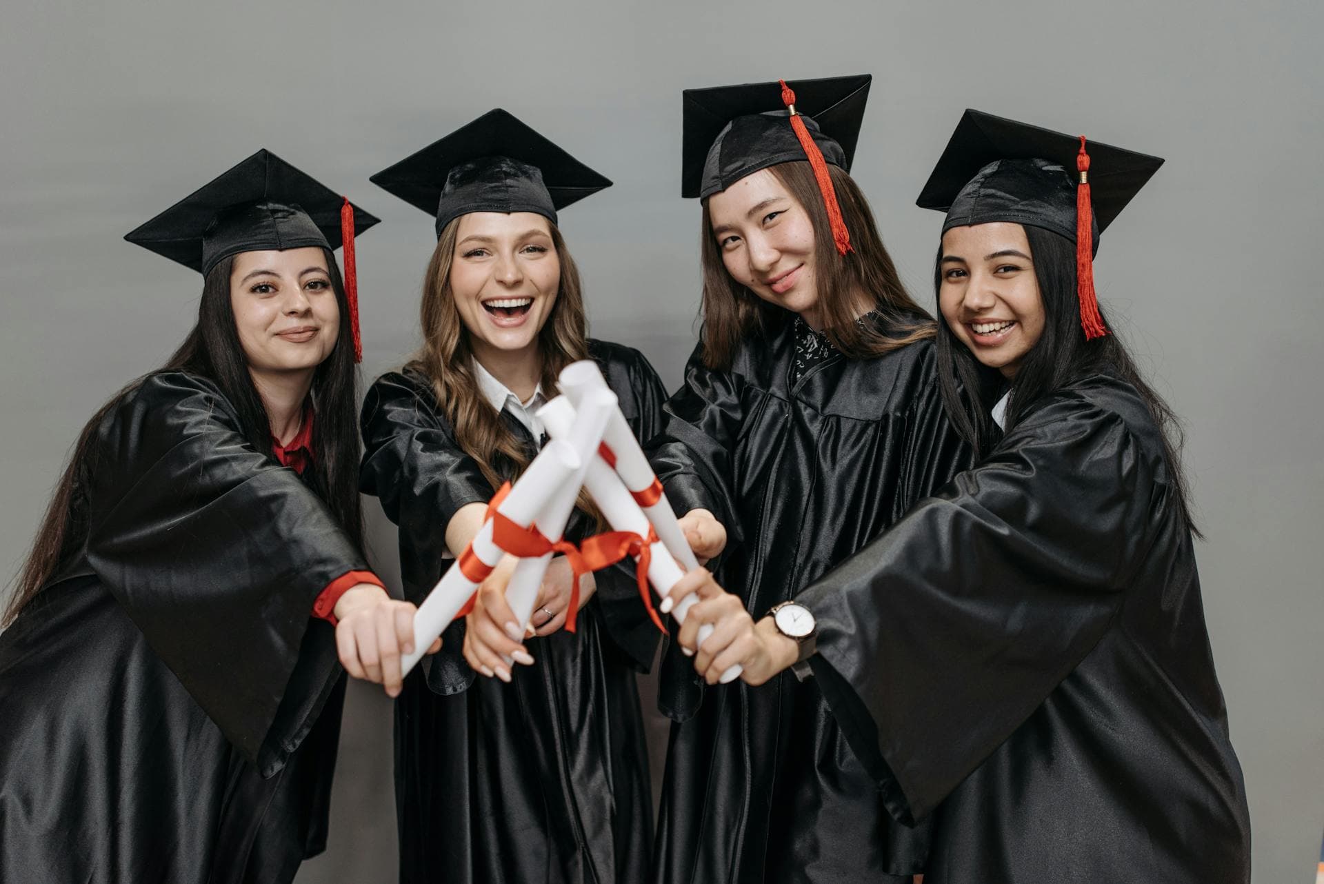 Graduates holding diplomas